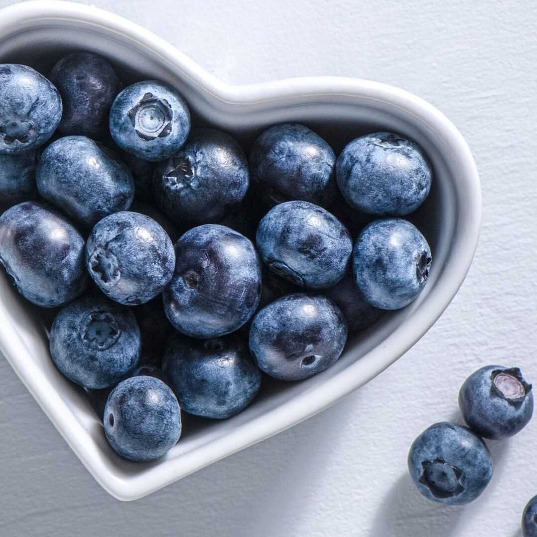 Fresh blueberries in a heart-shaped bowl